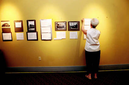 Marge Berchek works on hanging her exhibit on historic vaudeville and moving picture theaters in Columbia. On display at the Missouri Theatre, the exhibit will open in July. Marge Berchek works on hanging her exhibit on historic vaudeville and moving picture theaters in Columbia. On display at the Missouri Theatre, the exhibit will open in July.