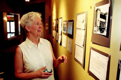 Marge Berchek works on hanging her exhibit on historic vaudeville and moving picture theaters in Columbia. On display at the Missouri Theatre, the exhibit will open in July. Marge Berchek works on hanging her exhibit on historic vaudeville and moving picture theaters in Columbia. On display at the Missouri Theatre, the exhibit will open in July.