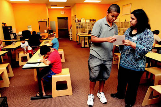 Director Manjula Narasimhan, right, reviews daily assignments with Noah Jackson at the Kumon Math and Reading Center.