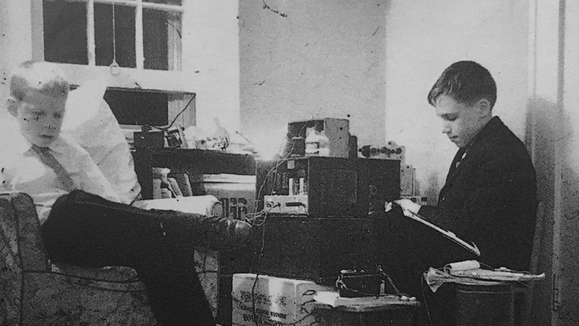 Al Germond, right, exploring his radio equipment.