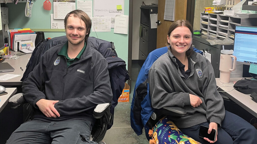 Zane and Emily sitting in the Animal Control office.
